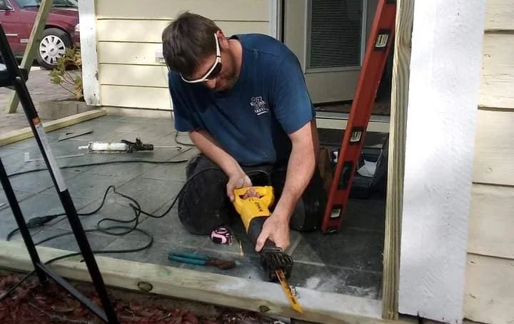 General contractor from All U Need preparing a porch for framing a sunroom.
